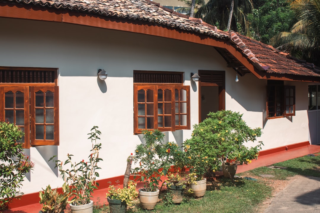 A house with wooden window frames and a red roof.